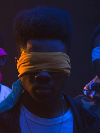 unrecognizable black gang in blindfolds on dark background