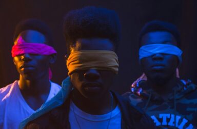 unrecognizable black gang in blindfolds on dark background